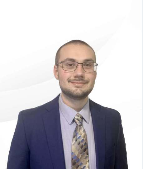 Image of Cody Adams, owner of CMA Accounting and Bookkeeping. A Caucasian Male with brown hair and facial hair wearing a blue suit and tie. 